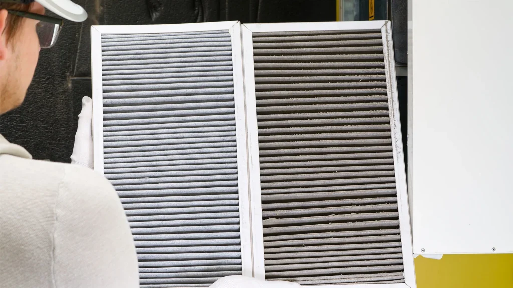 HVAC technician replacing dirty filters from an HVAC system