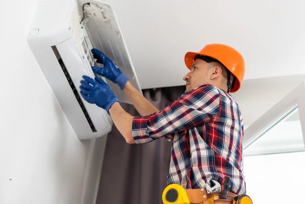 Technician repairing air conditioner